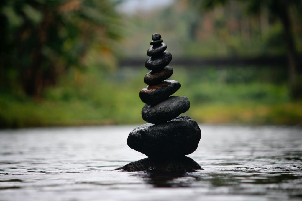 black stackable stone decor at the body of water